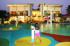 view of main building from pool area / unknown girl playing with water gun